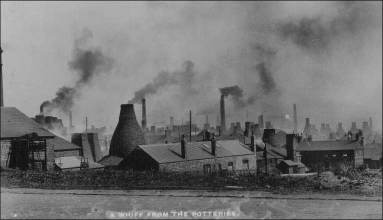 Black and white photograph of smoking bottle oven chimneys in the Potteries