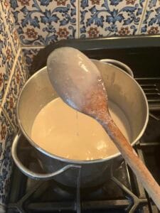 chicken soup coating the back of a wooden spoon