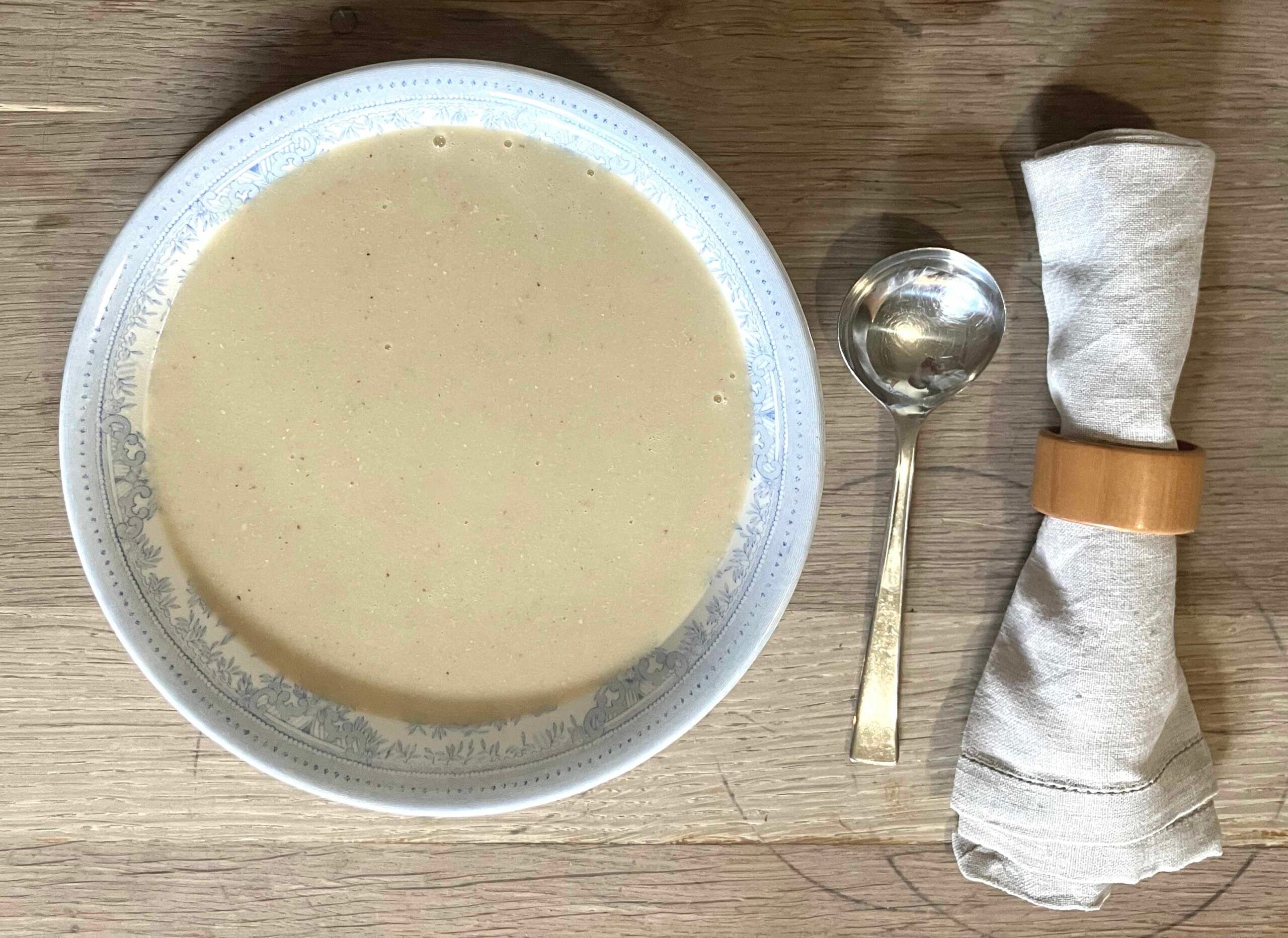 Cream of chicken soup in a bowl with a spoon and napkin